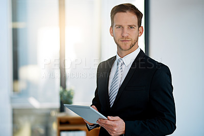 Buy stock photo Portrait of a corporate businessman working on his tablet in the office