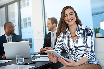 Buy stock photo Portrait of a young businesswoman working in the boardroom with her colleagues in the background