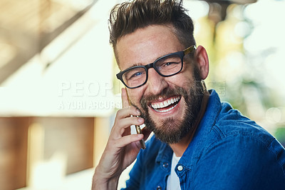 Buy stock photo Cropped shot of a handsome young man talking on a cellphone