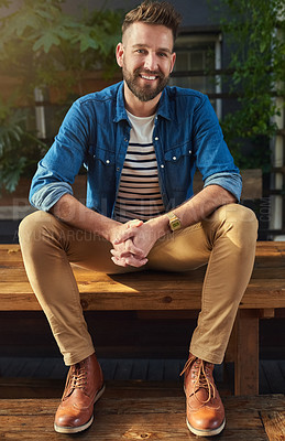 Buy stock photo Portrait, man and smile and relax, bench and casual while bearded, fashion and happy. Confident, travel and vacation in holiday, break and tourist with hands together, restaurant and male person