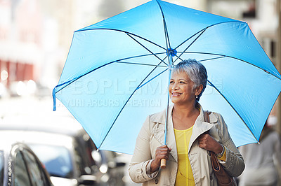 Buy stock photo Walking, umbrella and senior happy woman on city commute, travel and smile on urban journey. Winter weather, happiness and female person looking at Mexico street view, commuting and walk on road