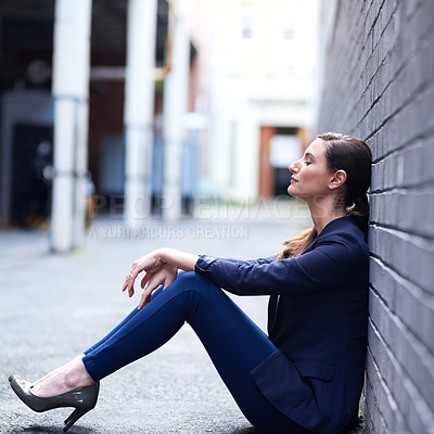 Buy stock photo Shot of an attractive businesswoman taking a break outside of her office
