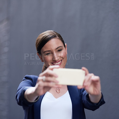 Buy stock photo Shot of a happy businesswoman having fun with her smartphone