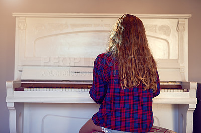 Buy stock photo Rear view shot of a young girl playing the piano