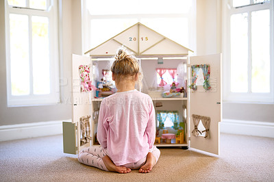 Buy stock photo Girl, dollhouse and home for playing, toys and fun in adorable, child and miniature. Creative, games and pretend for learning, development and young with mini furniture, enjoy and rear view or kid