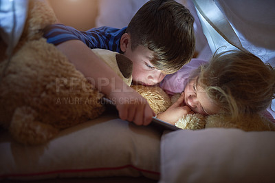 Buy stock photo Tablet, siblings or children with blanket in home for learning, streaming or watching cartoons. Family, brother and sister with technology for online video, game and movie while relaxing in house