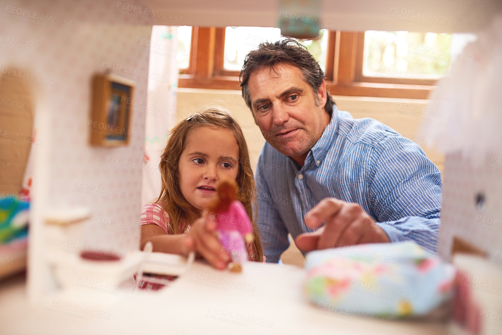 Buy stock photo Cropped shot of a father and daughter playing together with a dollhouse at home