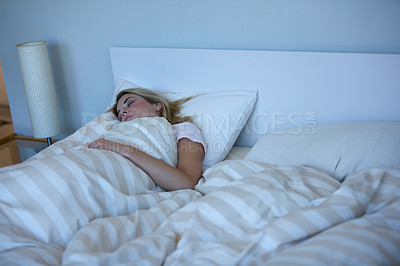 Buy stock photo Shot of a beautiful woman sleeping peacefully in her bed