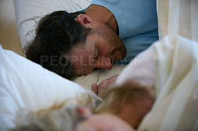 Buy stock photo Shot of a young couple fast asleep in bed