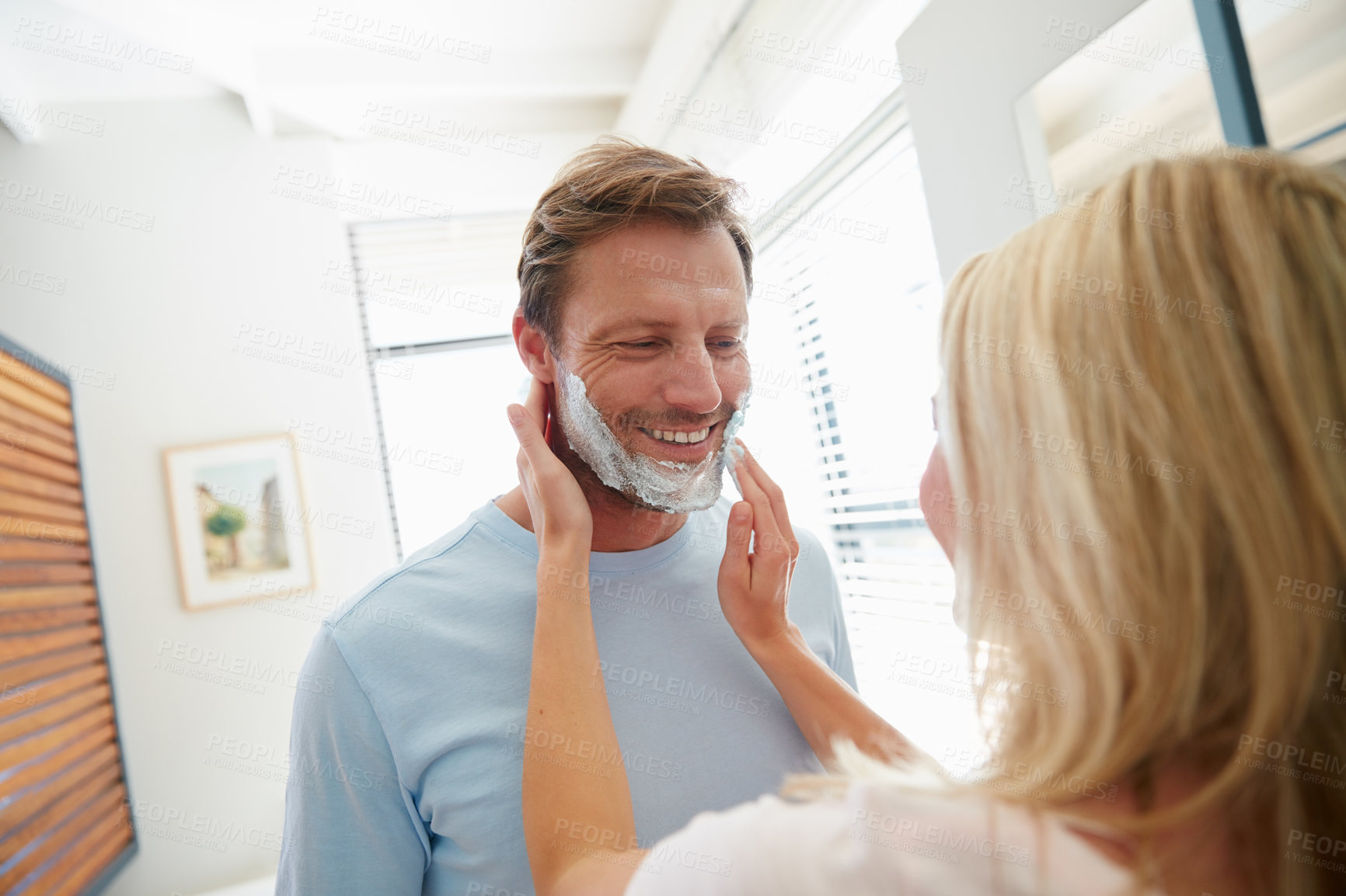 Buy stock photo Shot of a couple getting ready together in the bathroom