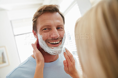 Buy stock photo Shot of a couple getting ready together in the bathroom