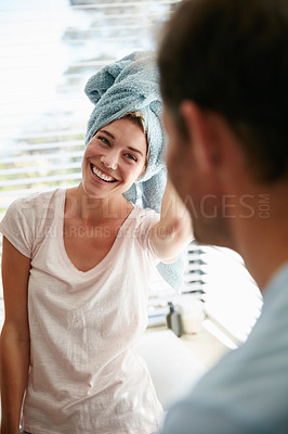 Buy stock photo Shot of a young couple getting ready in the bathroom