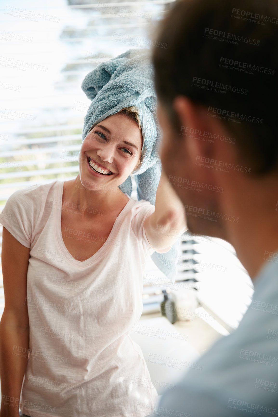Buy stock photo Shot of a young couple getting ready in the bathroom