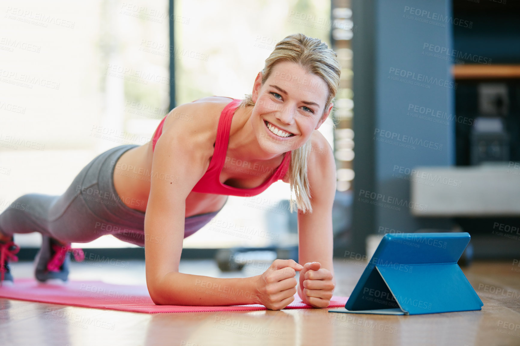 Buy stock photo Portrait of a sporty young woman working out at home