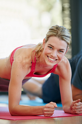 Buy stock photo Portrait of a sporty young woman working out at home