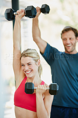 Buy stock photo Cropped shot of a sporty couple working out together at home