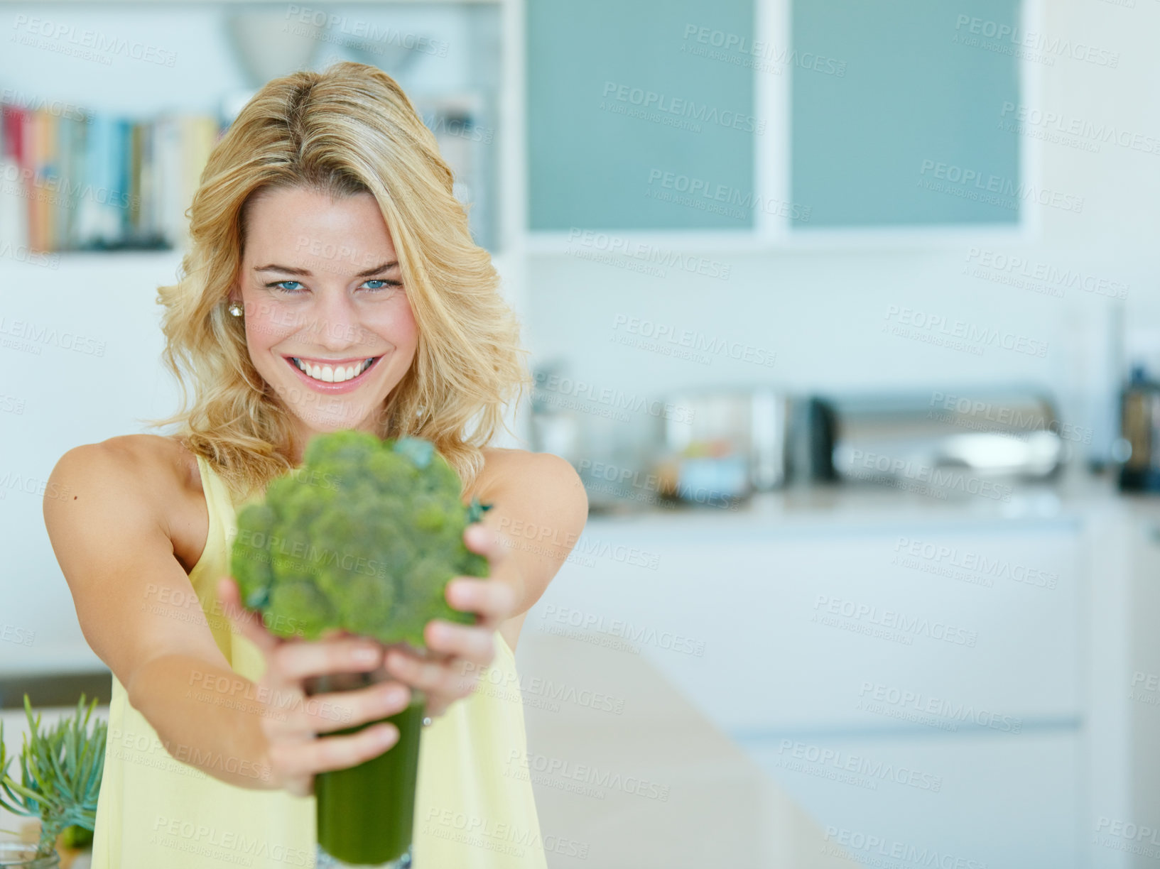 Buy stock photo Portrait of a happy young woman holding a broccoli  shake