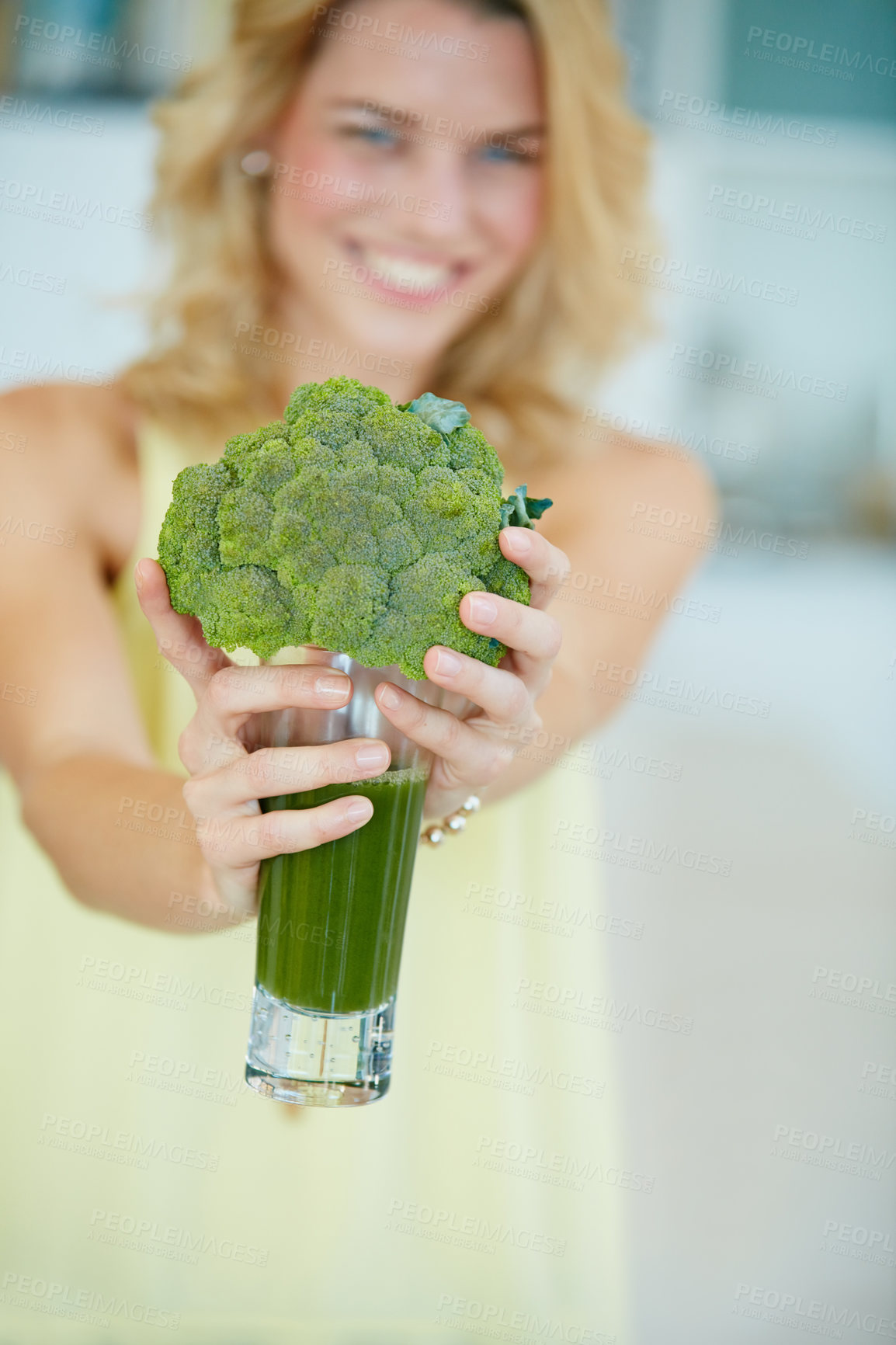 Buy stock photo Portrait of a happy young woman holding a broccoli  shake