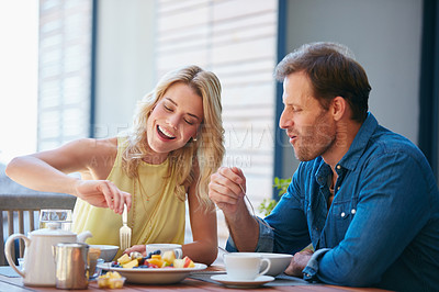 Buy stock photo Shot of a happy couple enjoying a healthy meal together at home