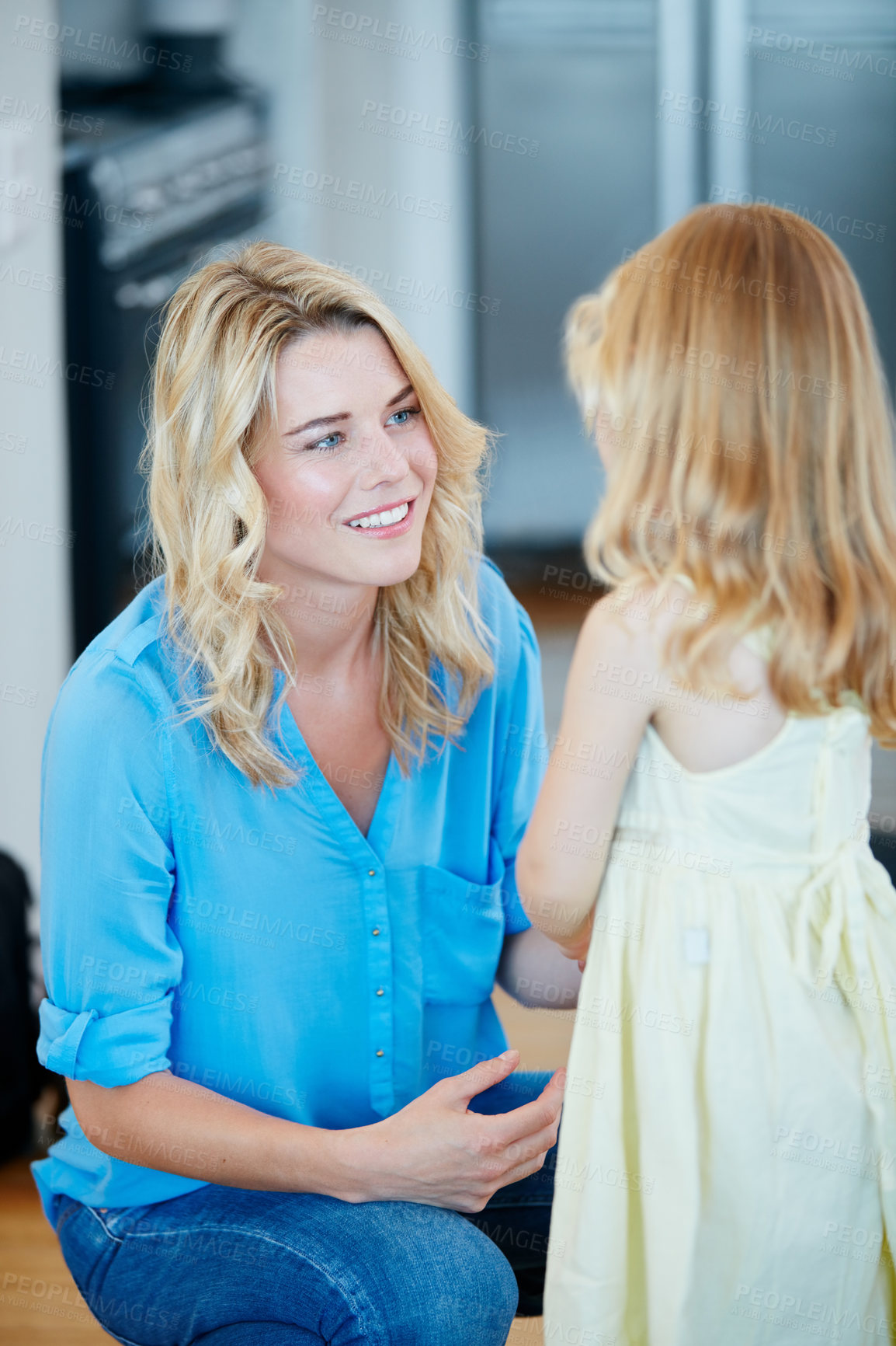 Buy stock photo Shot of a young mother talking to her daughter at home