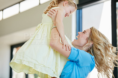 Buy stock photo Shot of a young mother playing with her daughter in their home