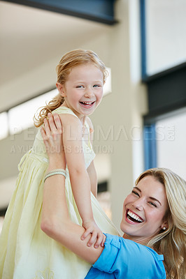 Buy stock photo Shot of a young mother playing with her daughter in their home