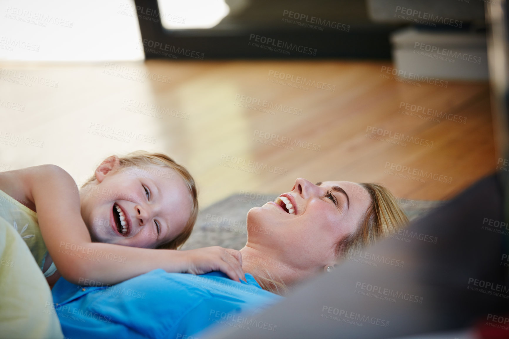 Buy stock photo Shot of a young mother playing with her daughter in their home