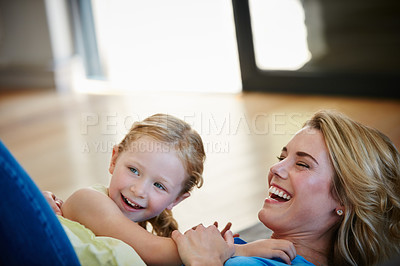 Buy stock photo Shot of a young mother playing with her daughter in their home