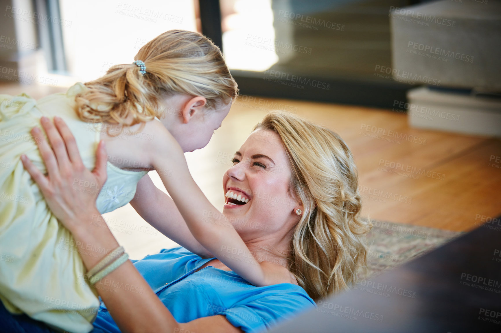 Buy stock photo Shot of a young mother playing with her daughter in their home