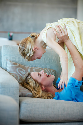 Buy stock photo Shot of a young mother playing with her daughter in their home