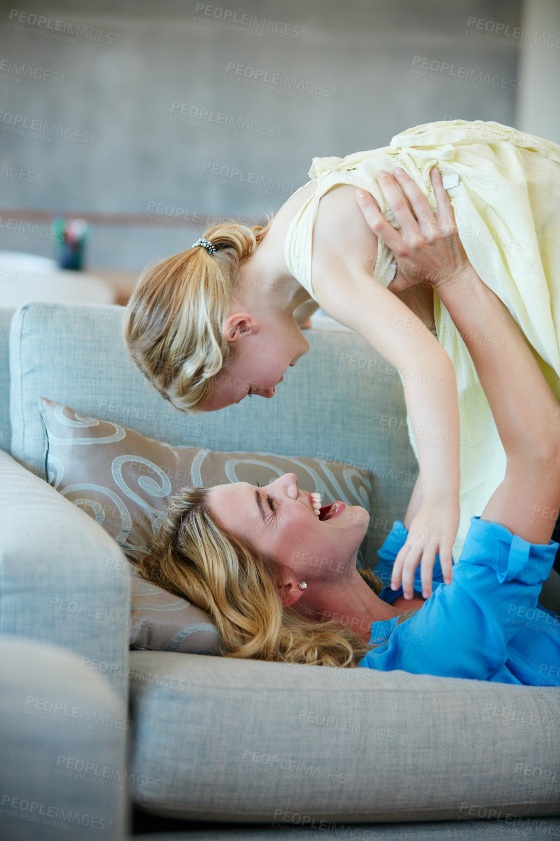 Buy stock photo Shot of a young mother playing with her daughter in their home