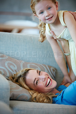 Buy stock photo Shot of a young mother playing with her daughter in their home