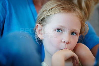 Buy stock photo Shot of a mother and her daughter sitting on the sofa at home