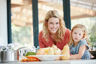 Buy stock photo Portrait of a mother and daughter preparing a meal together at home