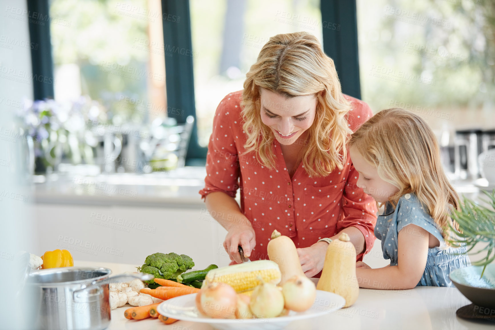 Buy stock photo Cropped shot of a mother and daughter preparing a meal together at home