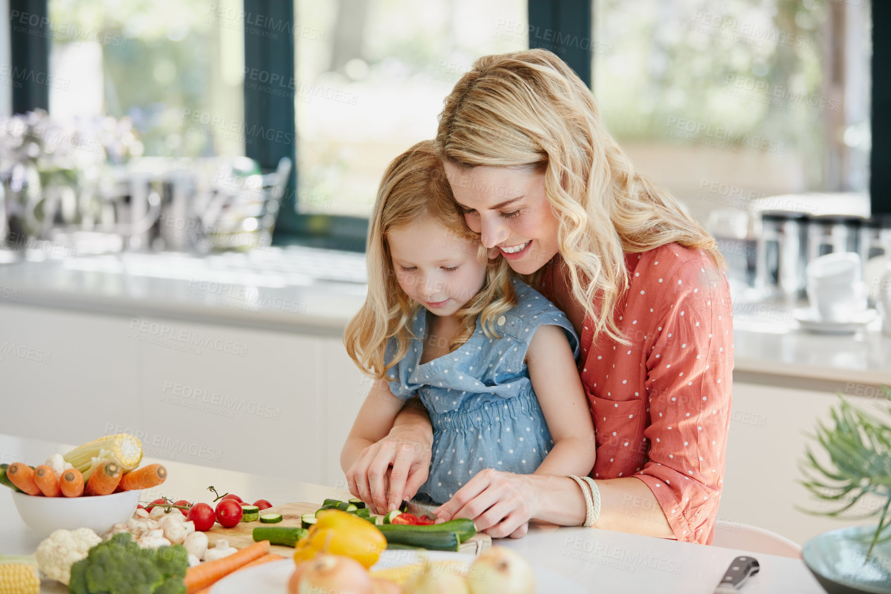 Buy stock photo Cropped shot of a mother and daughter preparing a meal together at home