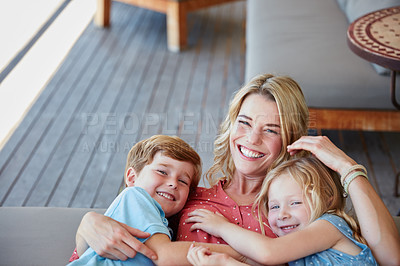 Buy stock photo Portrait of a mother and her two children spending quality time together outside