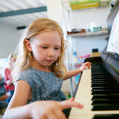 Buy stock photo Cropped shot of a little girl playing the piano