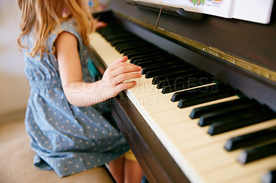 Buy stock photo Cropped shot of a little girl playing the piano