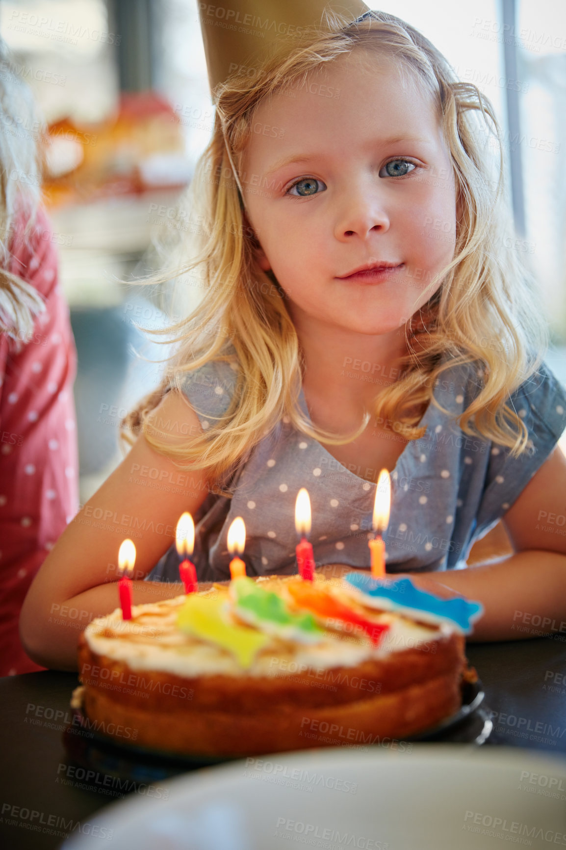 Buy stock photo Portrait of an adorable little girl sitting in front of her birthday cake