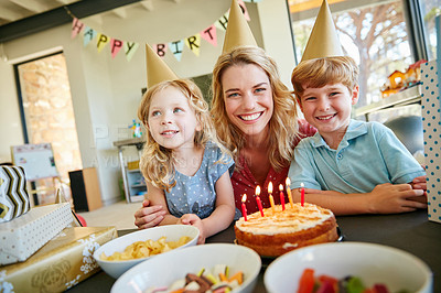 Buy stock photo Portrait of a mother and her two kids having a birthday party at home