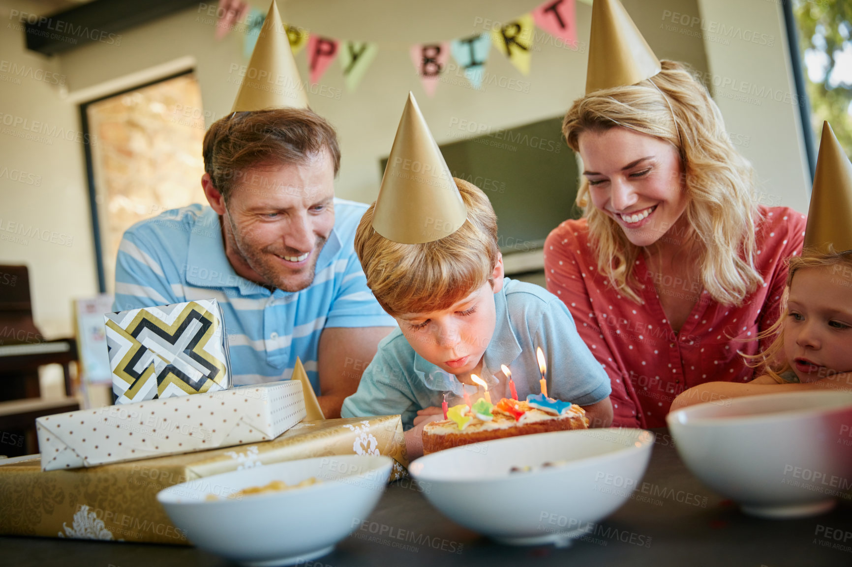 Buy stock photo Cropped shot of a happy family having a birthday party at home