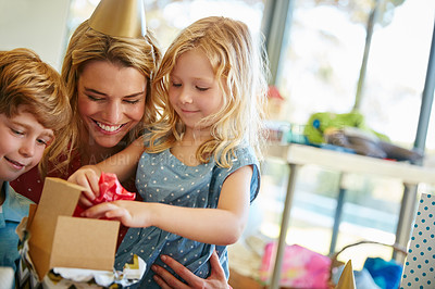 Buy stock photo Cropped shot of a mother and her two kids having a birthday party at home