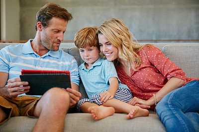 Buy stock photo Cropped shot of a family using a digital tablet together at home