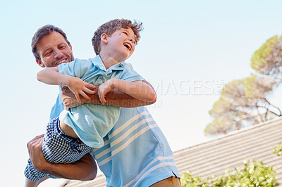 Buy stock photo Cropped shot of a father and son enjoying a day outdoors together