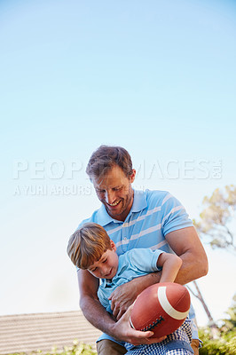 Buy stock photo Cropped shot of a father and son enjoying a day outdoors together