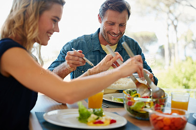 Buy stock photo Cropped shot of a couple enjoying a meal together at home