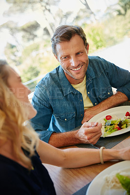 Buy stock photo Cropped shot of a couple enjoying a meal together at home
