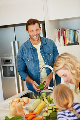 Buy stock photo Portrait of a father cooking together with his family at home