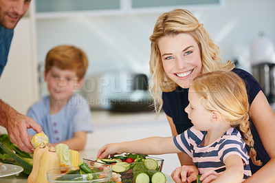 Buy stock photo Portrait of a mother cooking together with her family at home